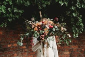 bride holding an autumn flower filled bouquet