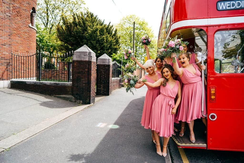 bridesmaids and a red bus