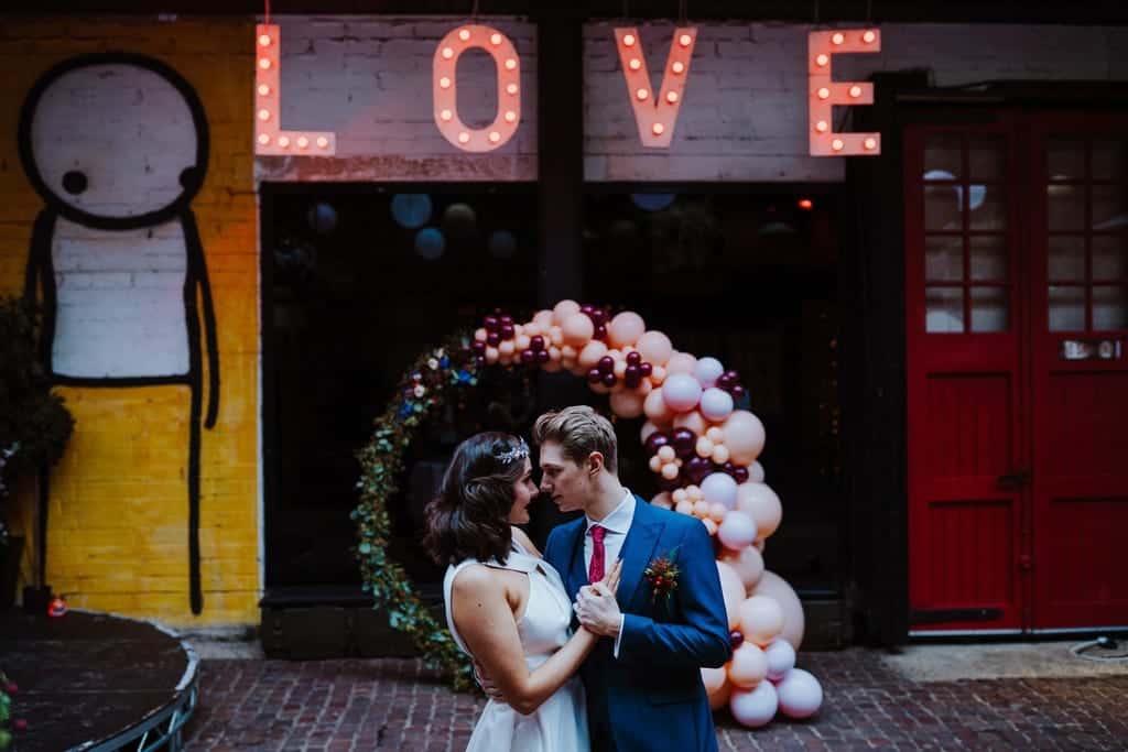 wedding couple with a love sign 