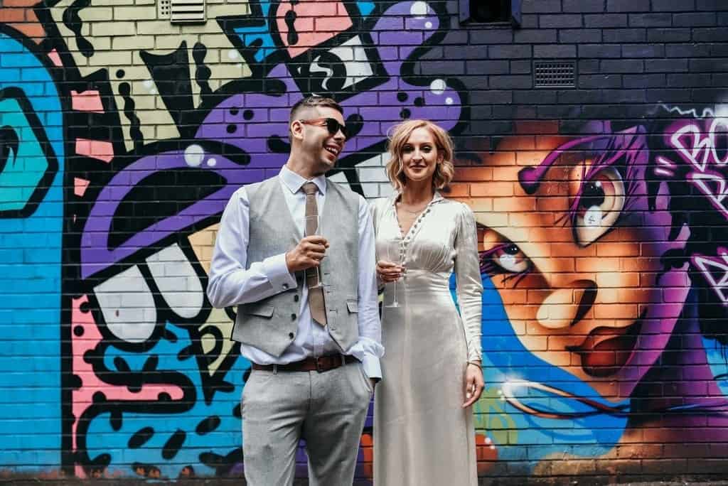 couple and a graffiti wall