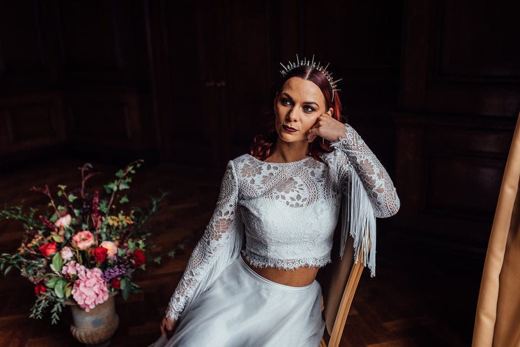 bride on a chair in a moody wedding styled shoot