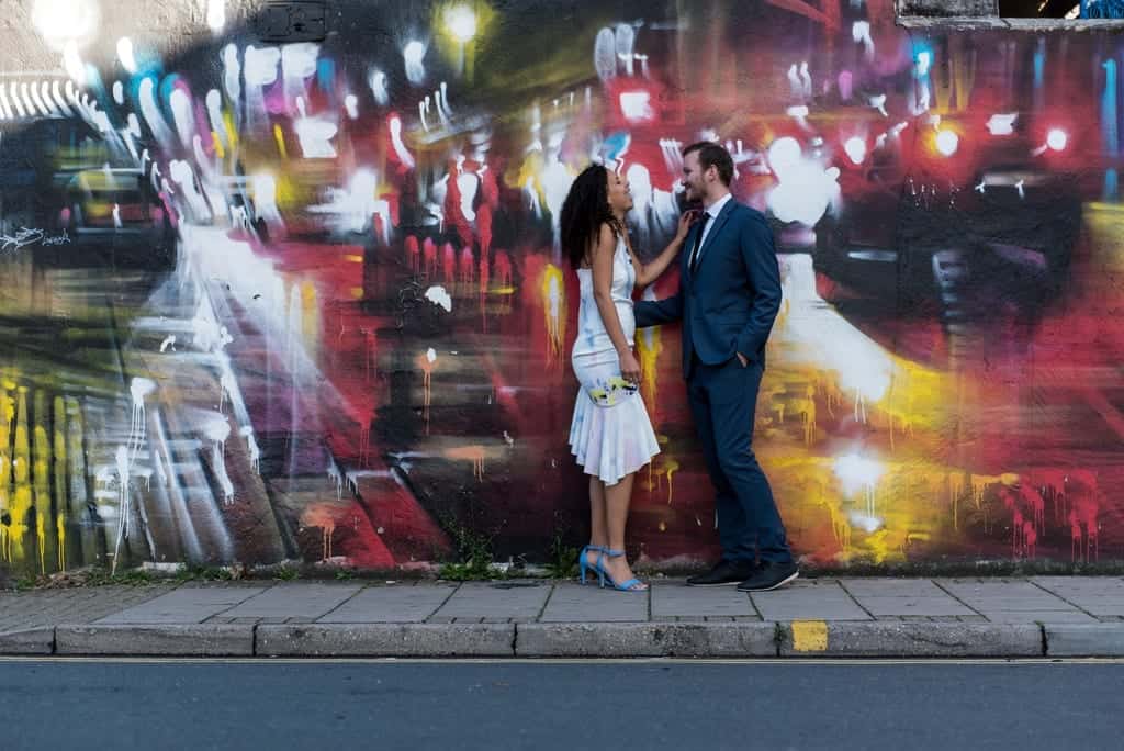 couple with an art work wall