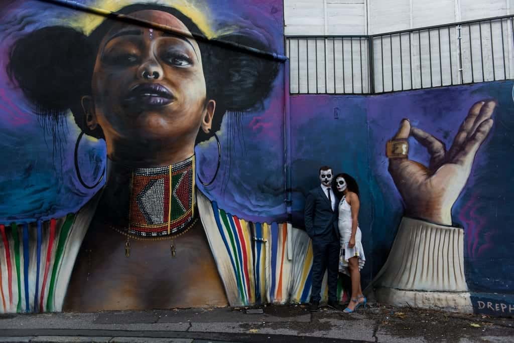 halloween couple and a painted wall