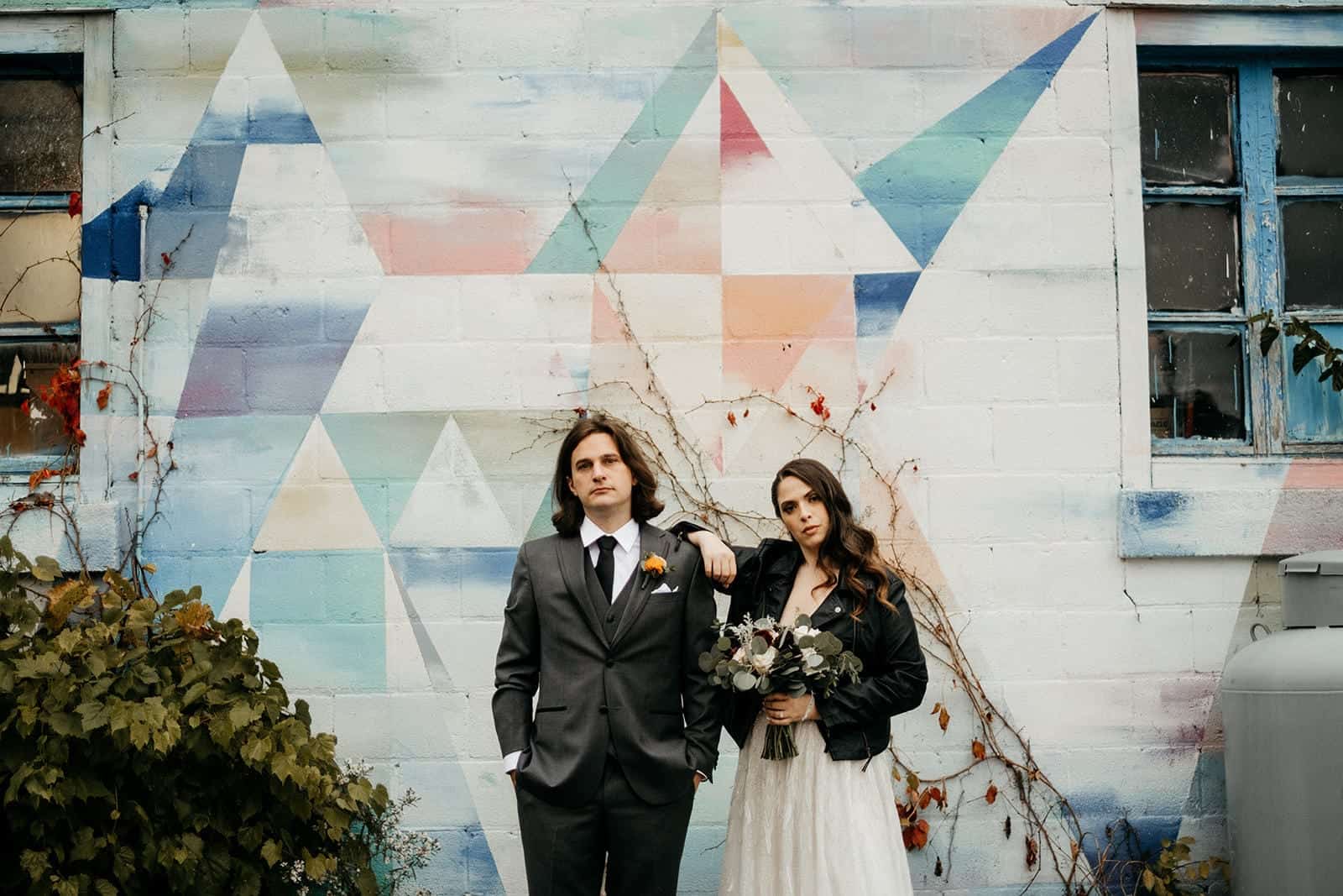 wedding couple and a cool wall 