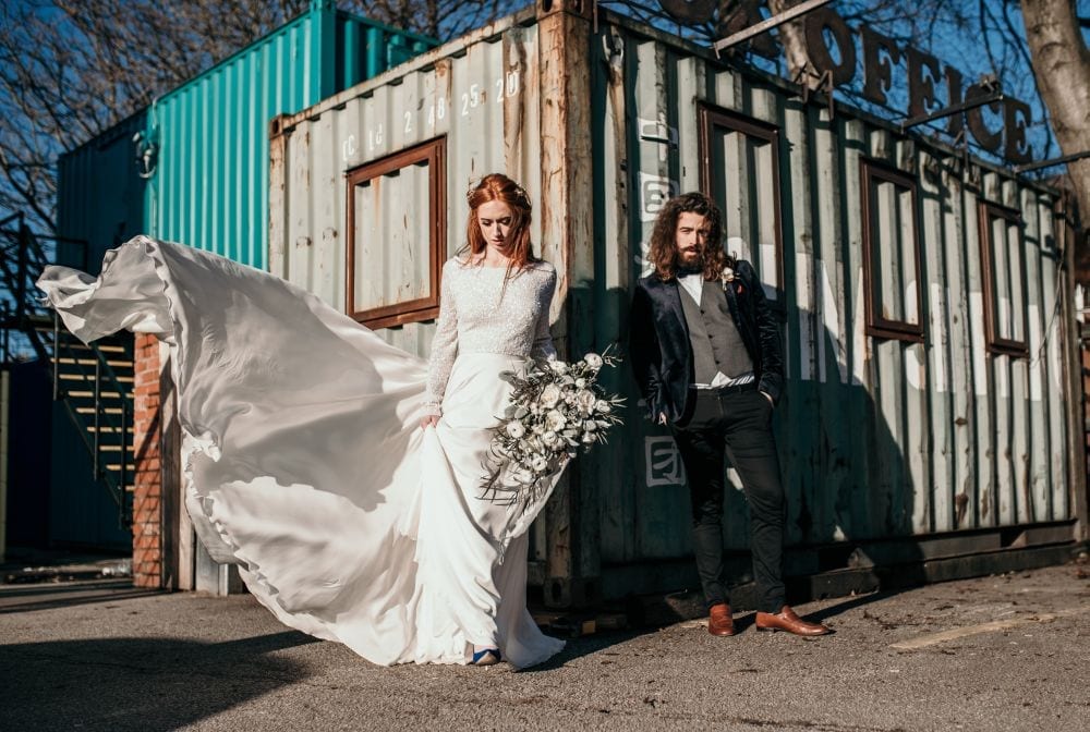bride and groom stood outside venue