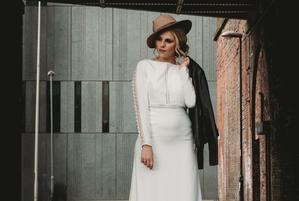 bride in long sleeve dress and hat 