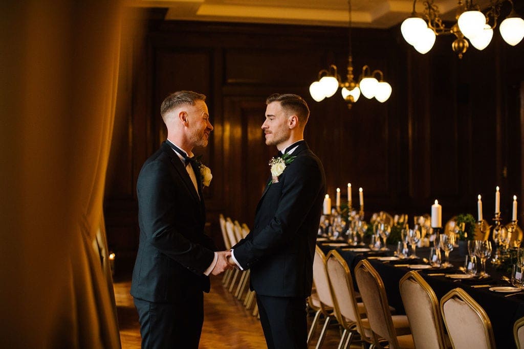 two grooms saying their vows