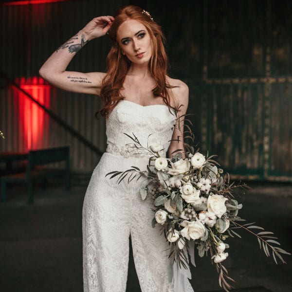 bridal jumpsuit with bouquet