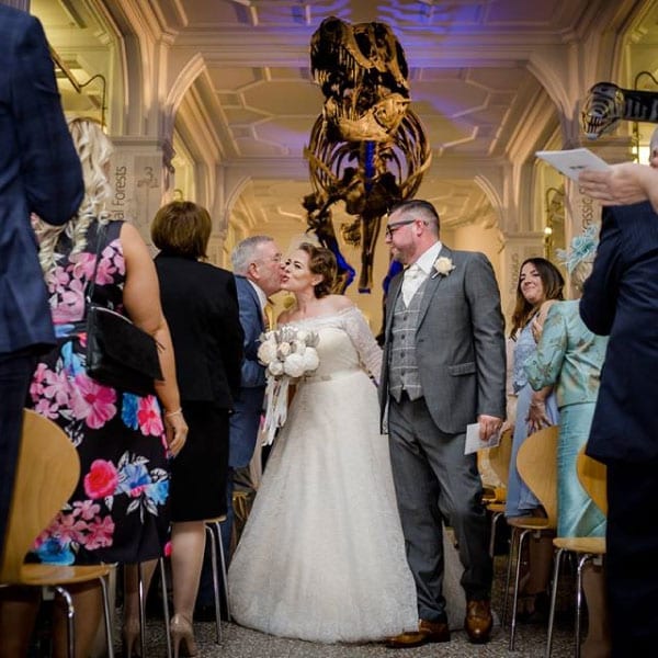 bride and groom walking down the aisle at museum 