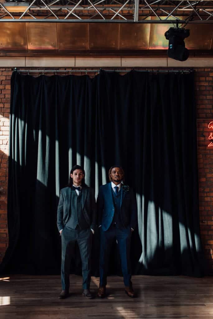 couple in front of theatre stage curtain 