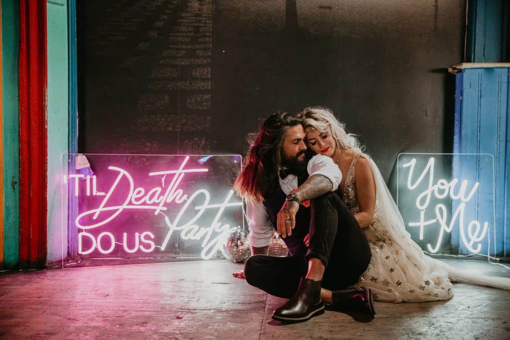 wedding couple and a neon sign