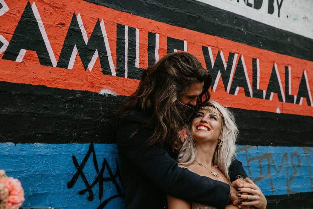 wedding couple and street graffiti