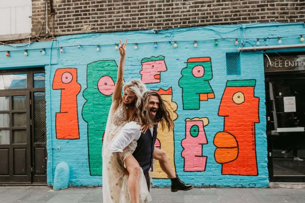 city couple and a grafitti wall