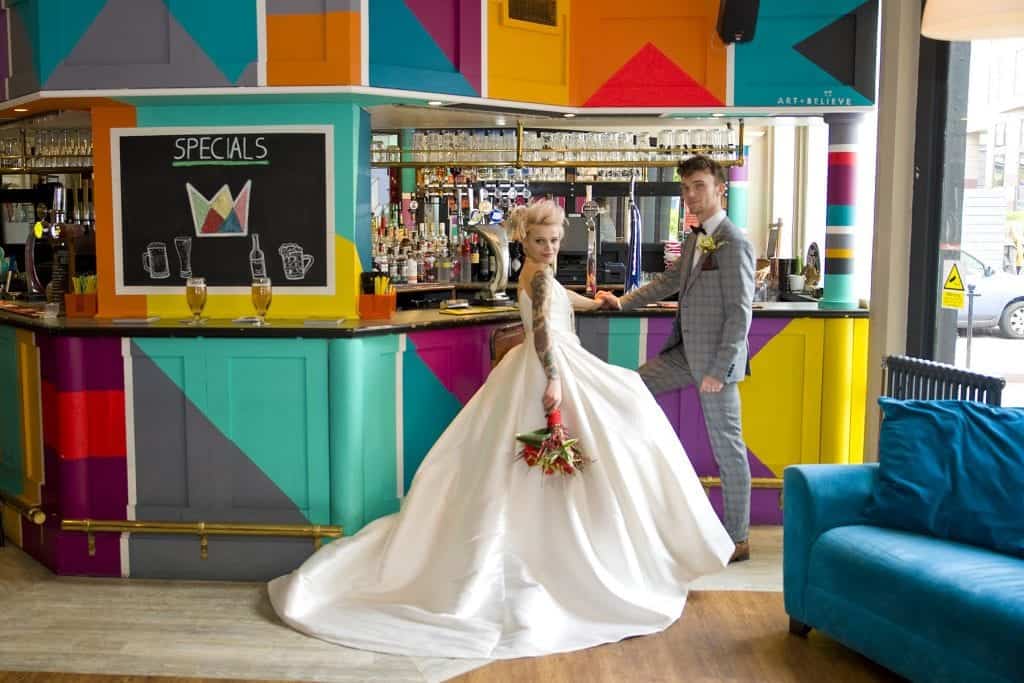 wedding couple in a colourful bar