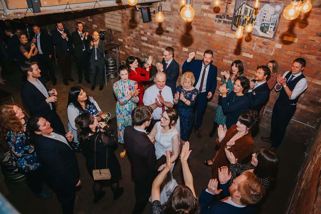 wedding guests all stood watching first dance