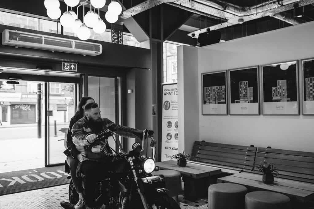 couple leaving wedding venue on bike