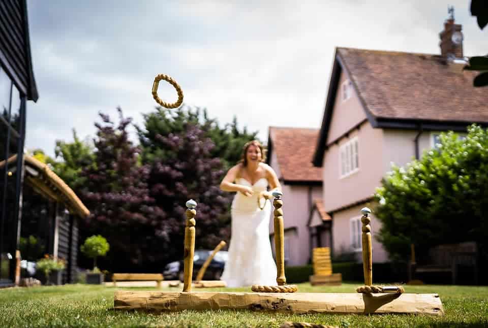 lawn game on grass with bride playing