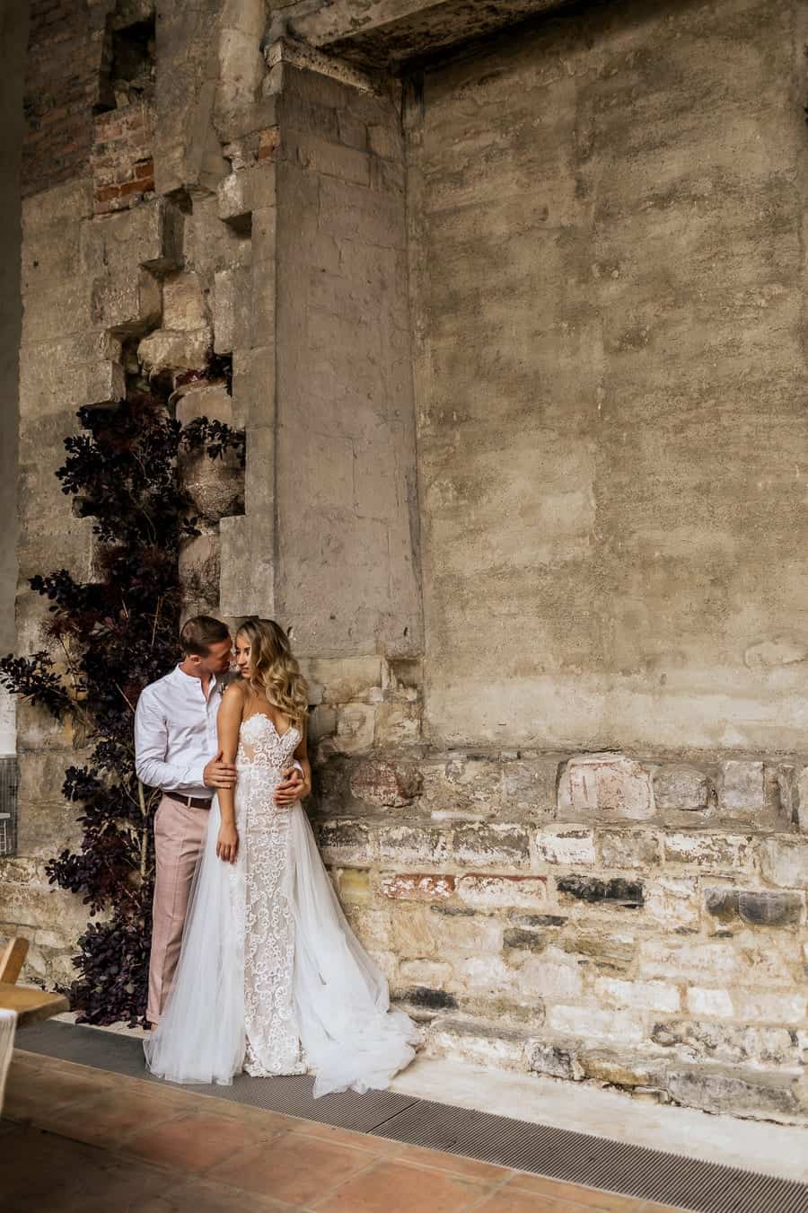 rustic wall and a wedding couple