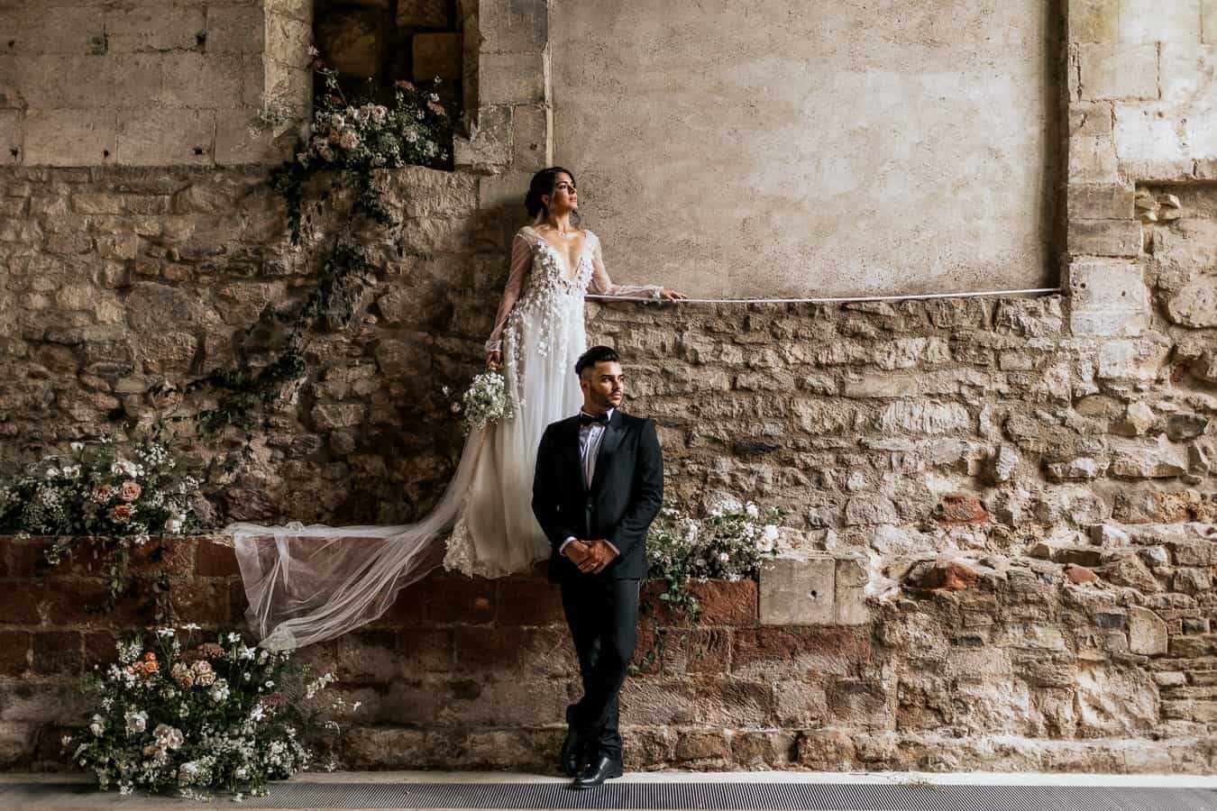 wedding couple and a rustic wall