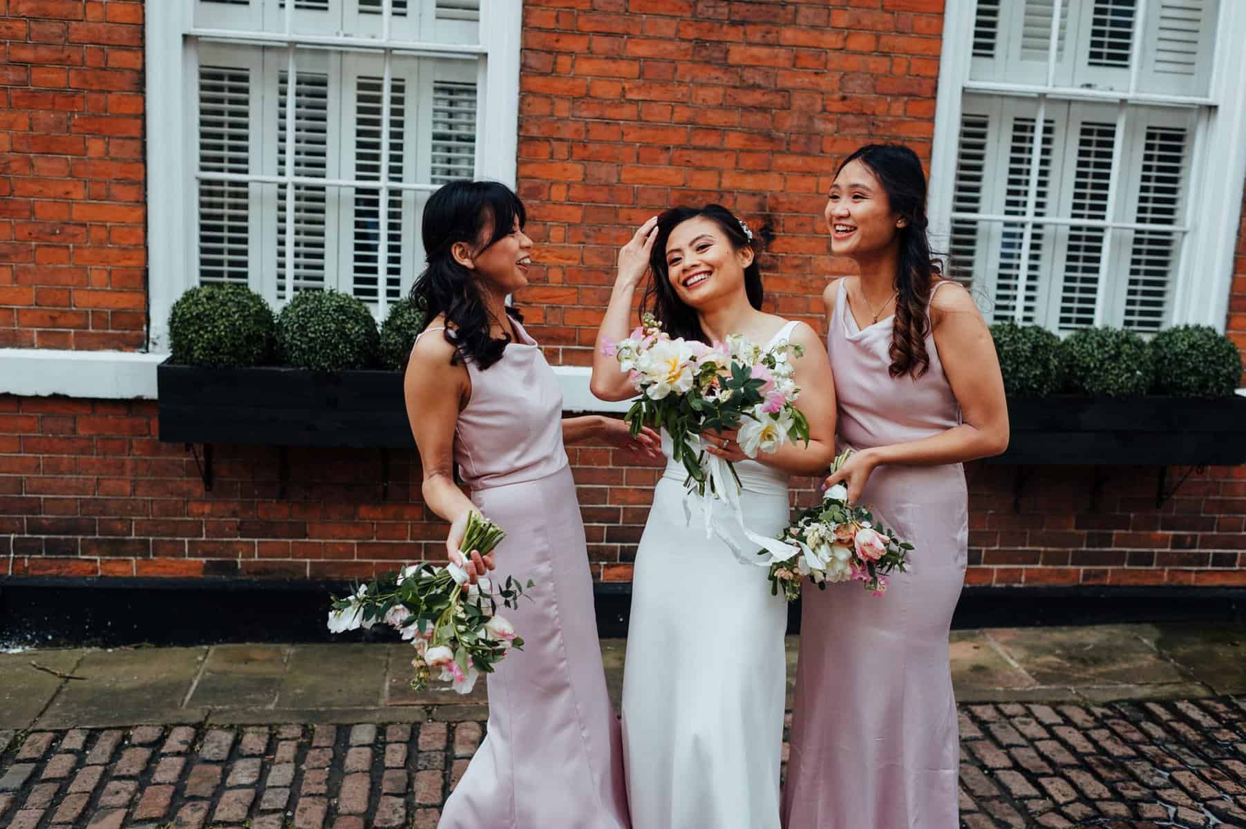 bride and bridesmaid on city street