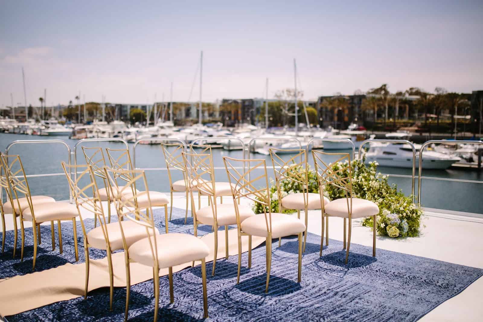yacht wedding ceremony set up with chairs and flowers 