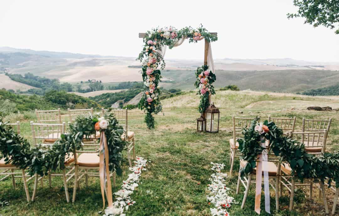 pagan ceremony set up outside with arch and chairs