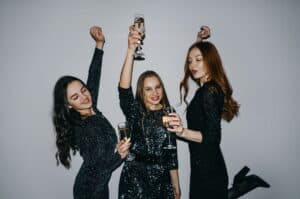 3 girls in black dresses celebrating