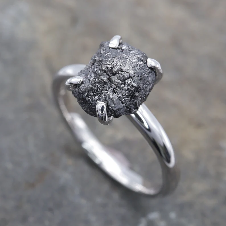 raw cut black diamond on a plain silver band