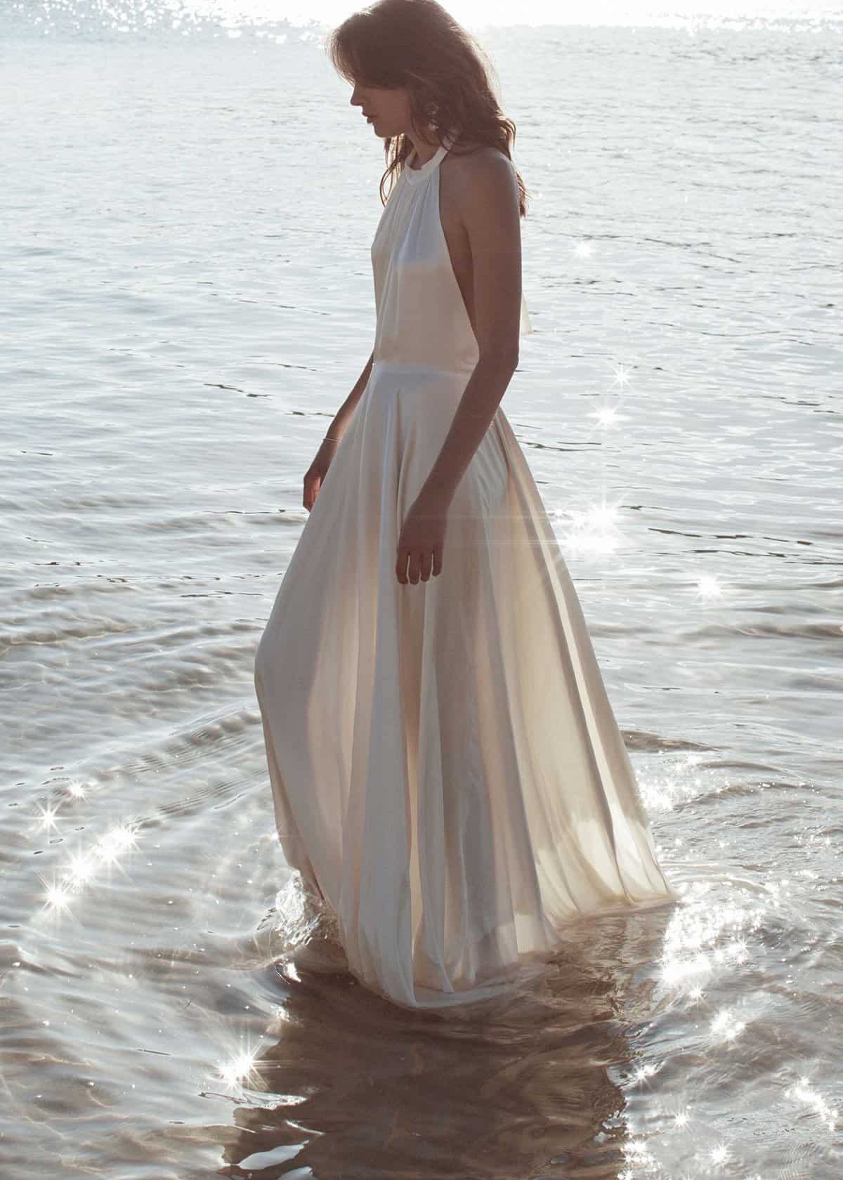 bride at beach wearing  halter dress