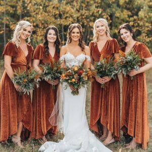 bride and bridesmaids posing in copper bridesmaid dresses