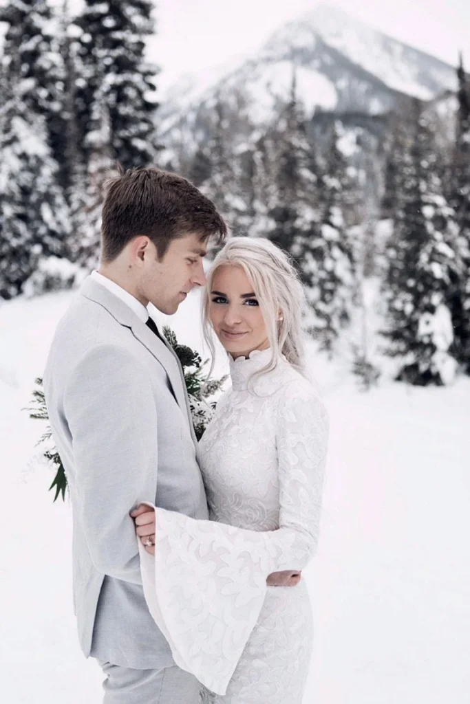 bride with groom wearing a turtle neck wedding dress in a winter setting