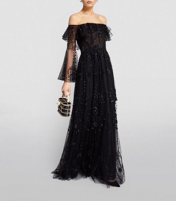 black dress made from lace with embellishments with long sleeves and off the shoulder