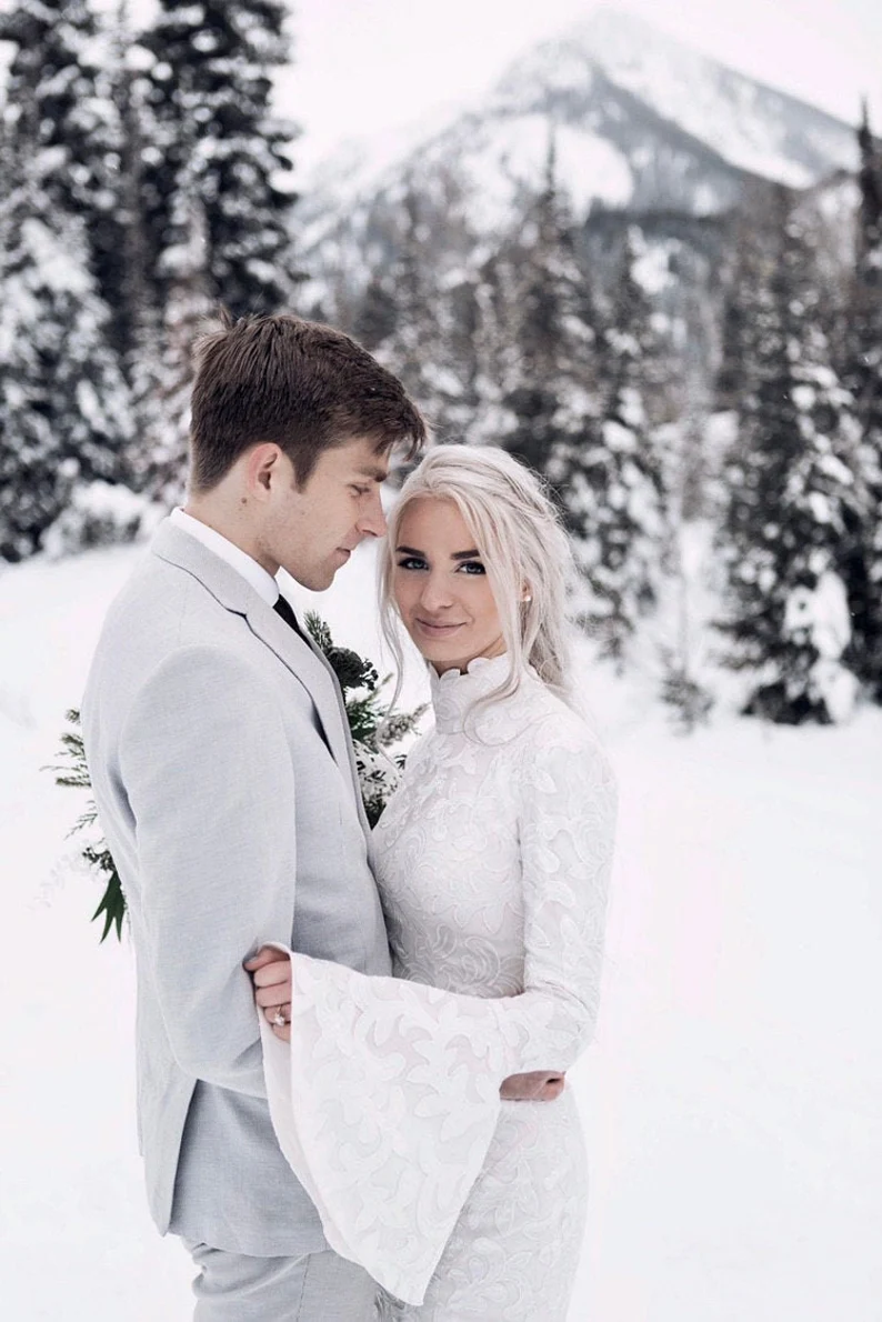 bride and grrom in snow, bride in a turtle neck lace dress
