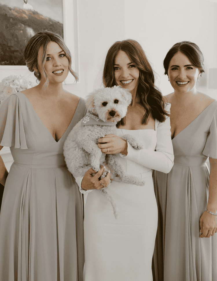 Bride and dog with two bridesmaids in green dresses