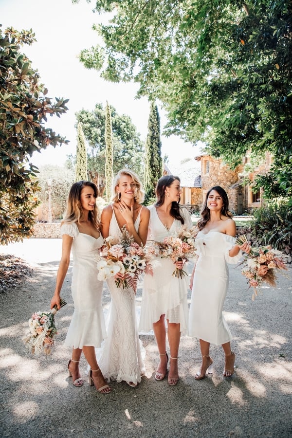 bride and 3 bridesmaids all in white on wedding day posing