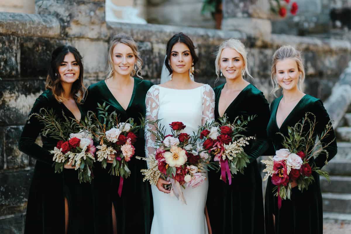 bride and bridesmaid in emerald green dresses