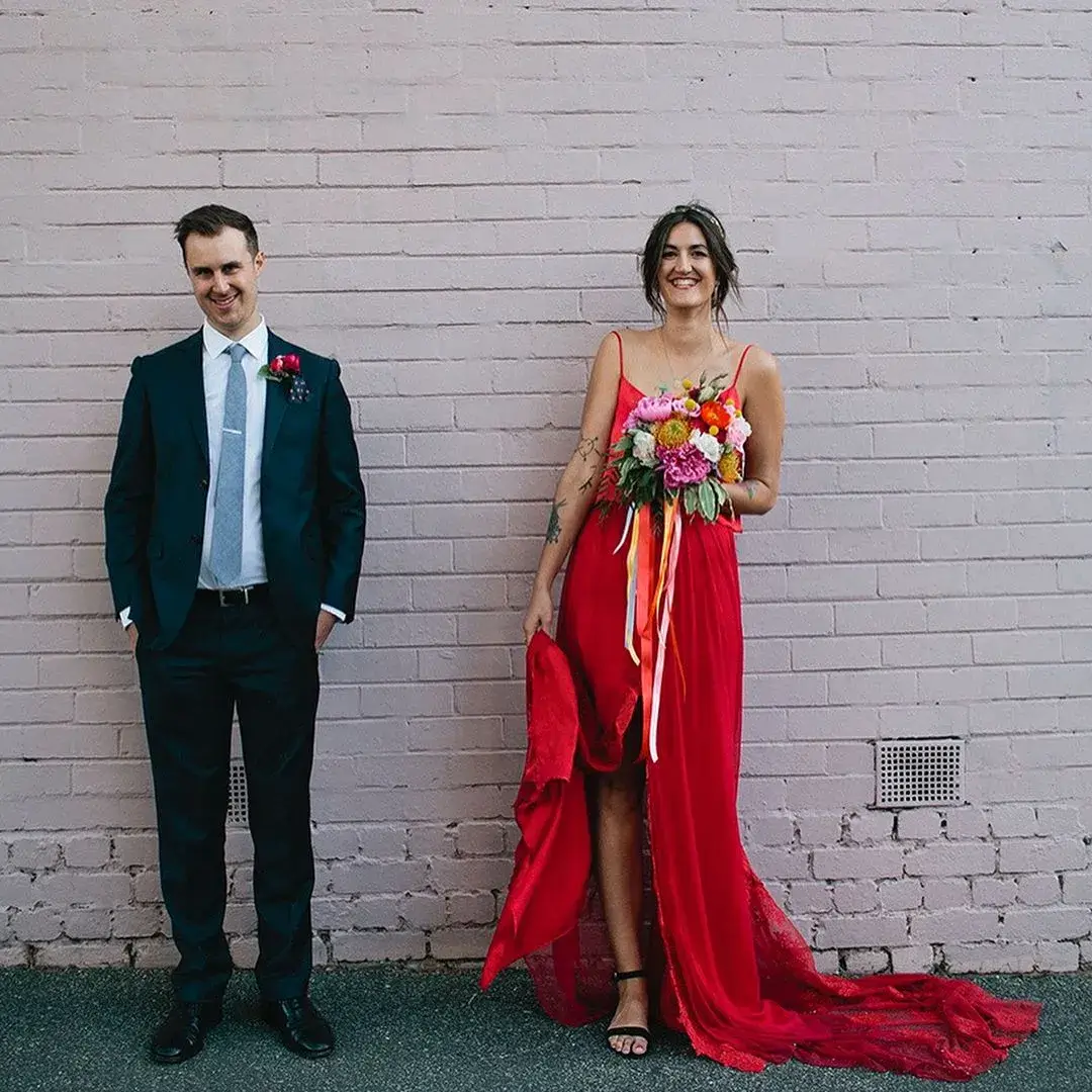 bride in red dress and groom in black suit