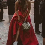 bride in red dress with white sneakers and white bouquet