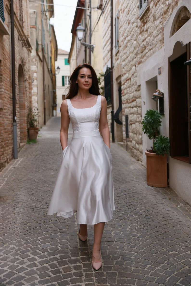 bride in simple knee length dress on old city strret