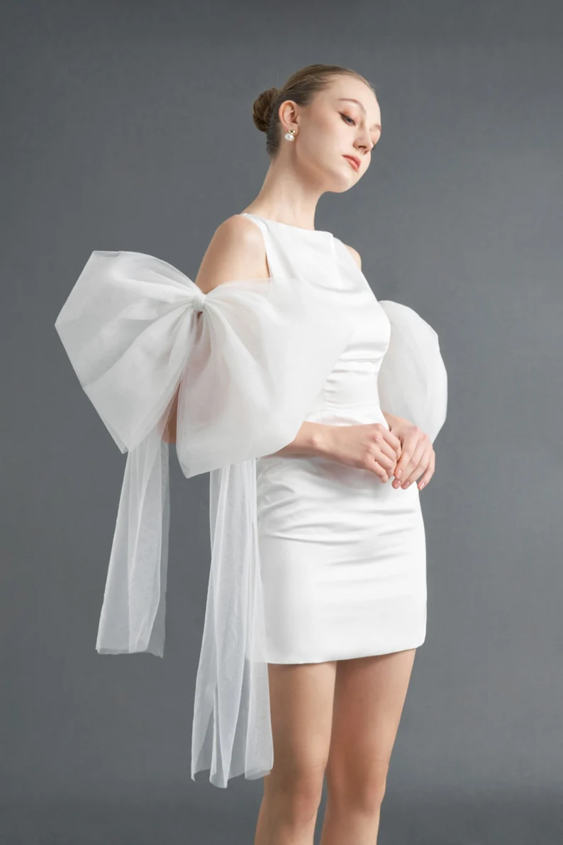 big bow bridal sleeve worn with short dress