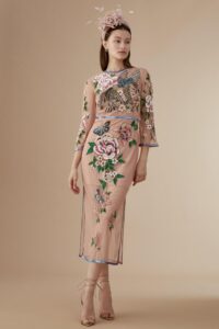 mother in embroidered blush dress with floral design