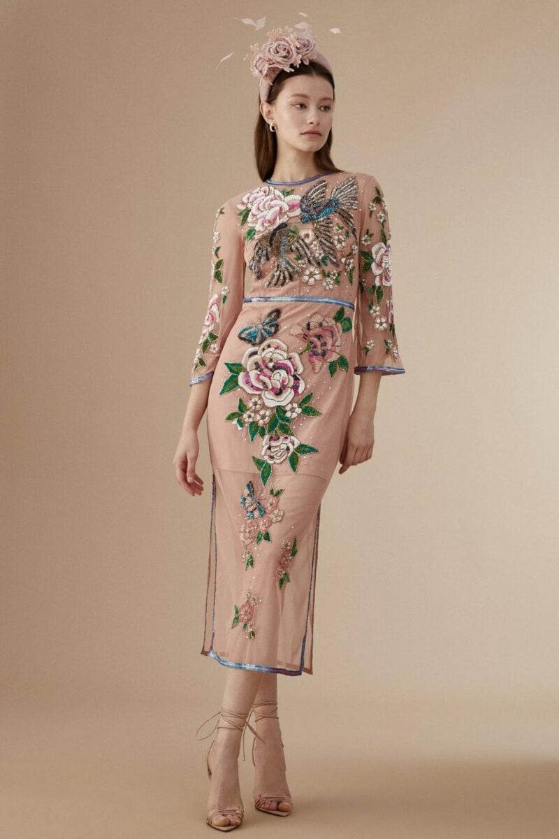 mother in embroidered blush dress with floral design