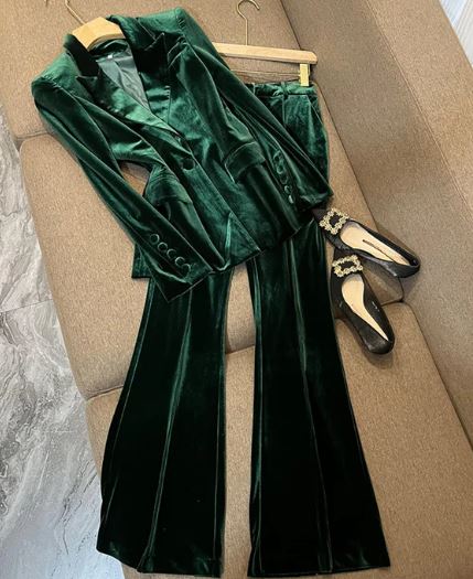 green velvet trouser suit layout with shoes on sofa