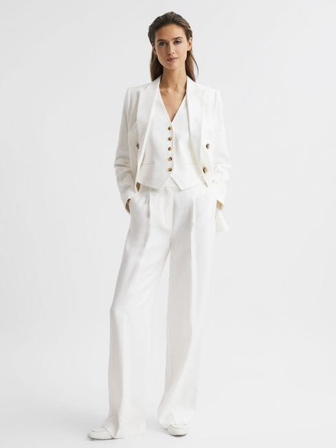 white suit with waist coat, jacket and pleated pants