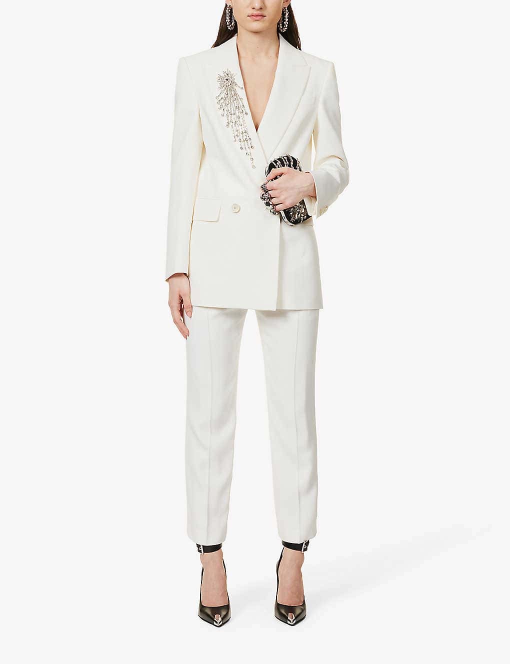 white suit with silver embellishments on coller 