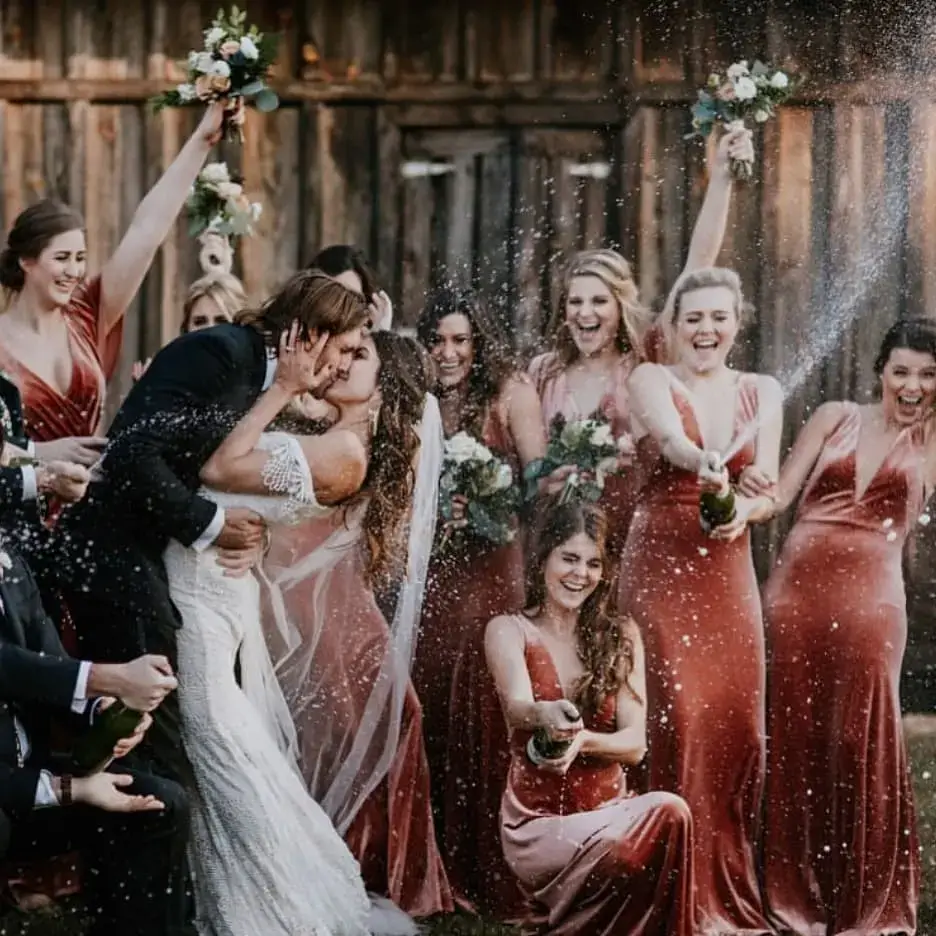 bridesmaid popping champagne
