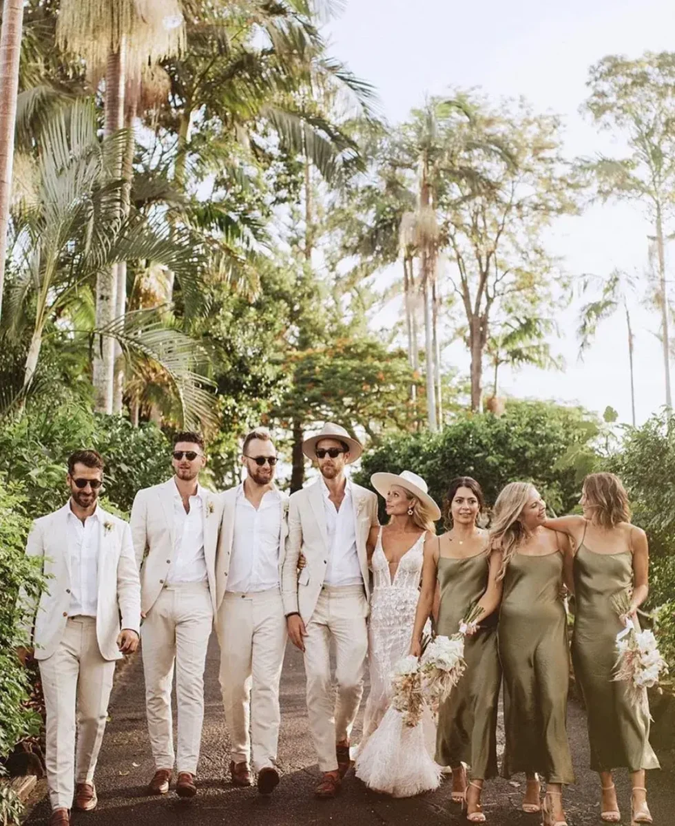 groomsmen in beige suits and bridesmaids in olive green dresses