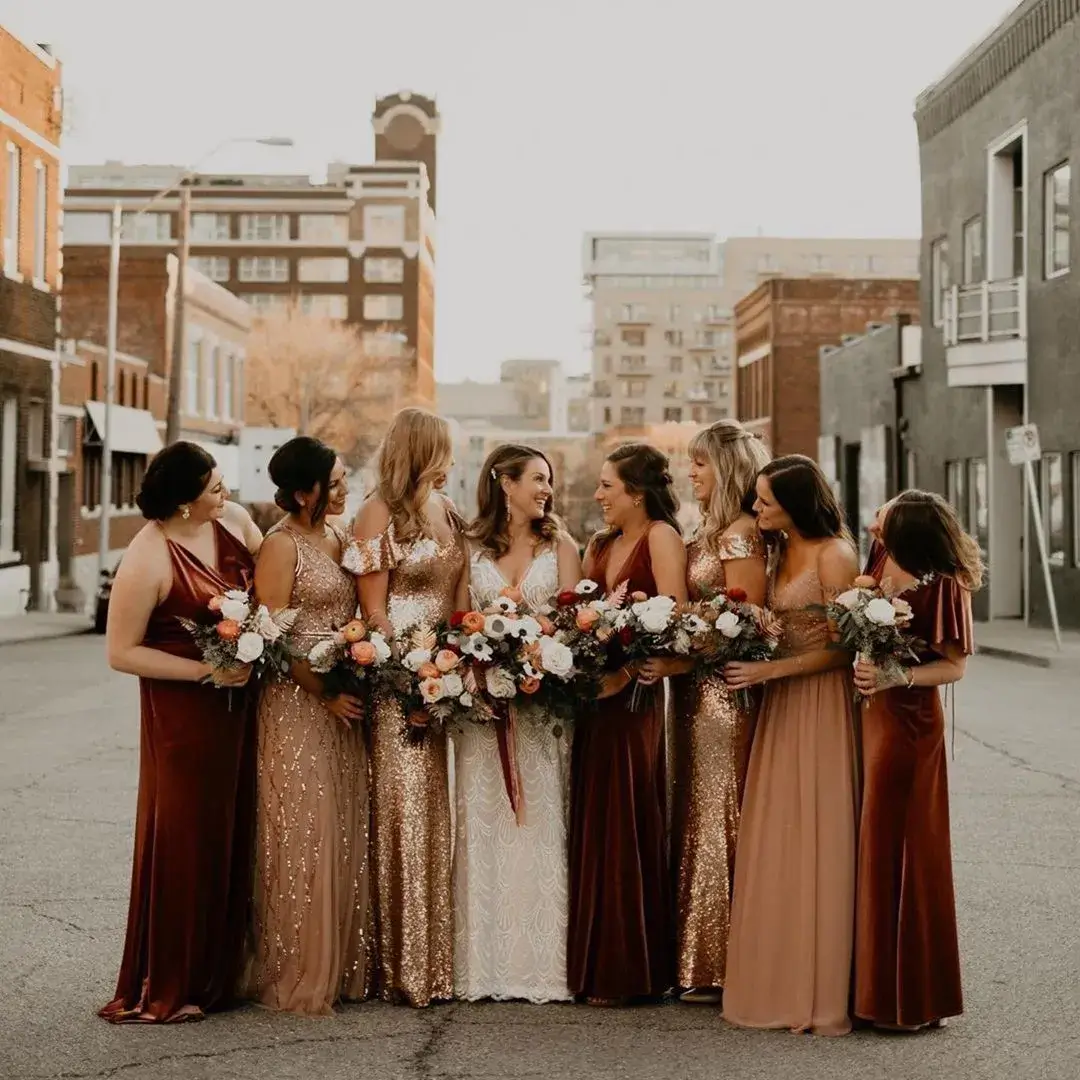 bride and bridesmaids in mixed browns and rust coloured velvet dresses