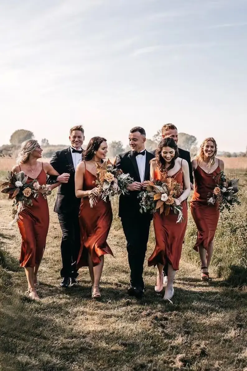 bridesmaid and groomsmen all together walking on path