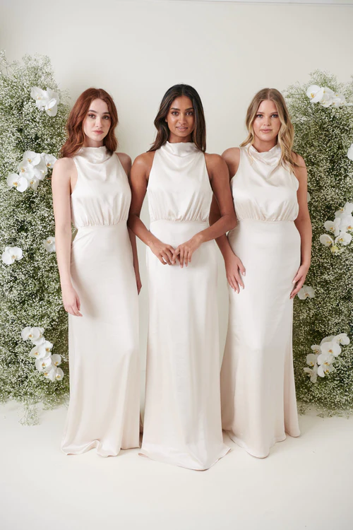 3 bridesmaid posing in same high neck champagne dresses